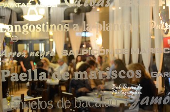 A view from the front door through an etched glass panel which lists menu items.